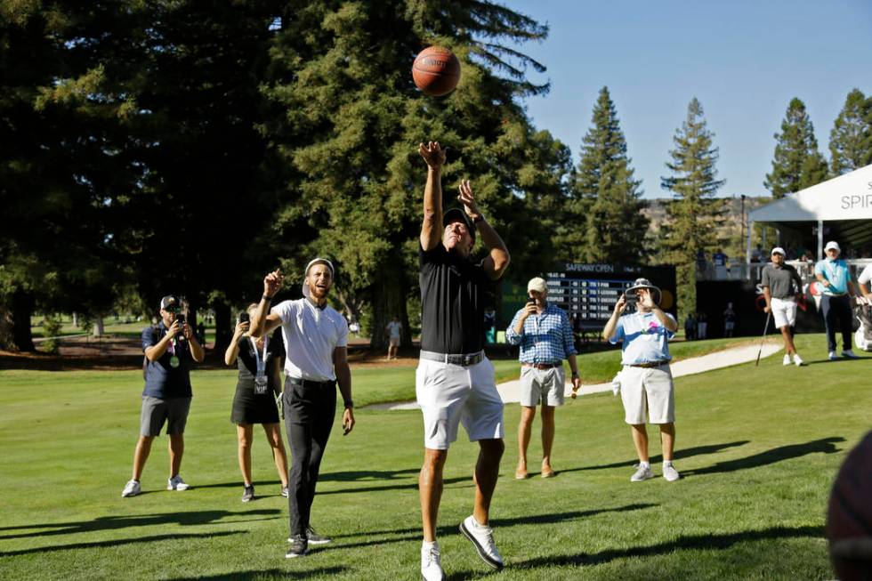 Phil Mickelson shoots a basketball below the 17th green of the Silverado Resort North Course as ...