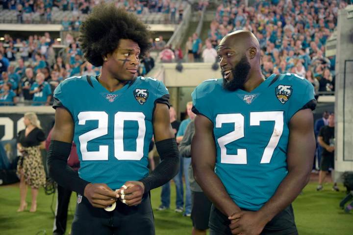 Jacksonville Jaguars cornerback Jalen Ramsey (20) talks to running back Leonard Fournette (27) ...