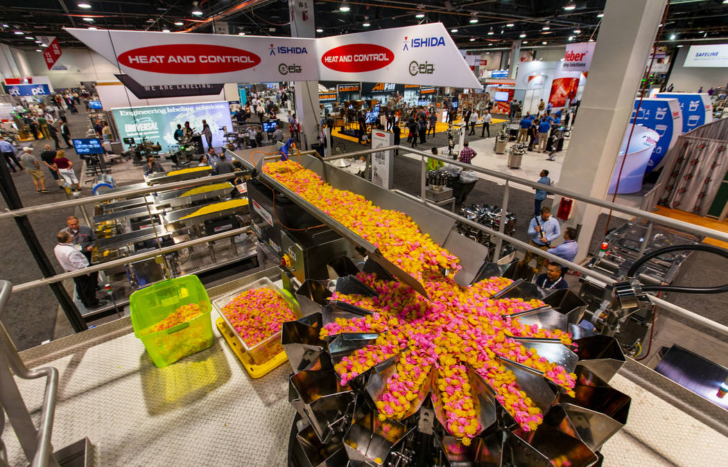 Product is processed by a Heat and Control FastBack horizontal motion conveyor on display at PA ...