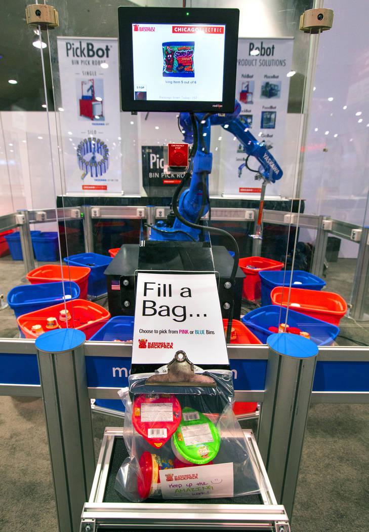 A robot from Chicago Electric packs school lunches for kids through Blessings in a Backpack at ...