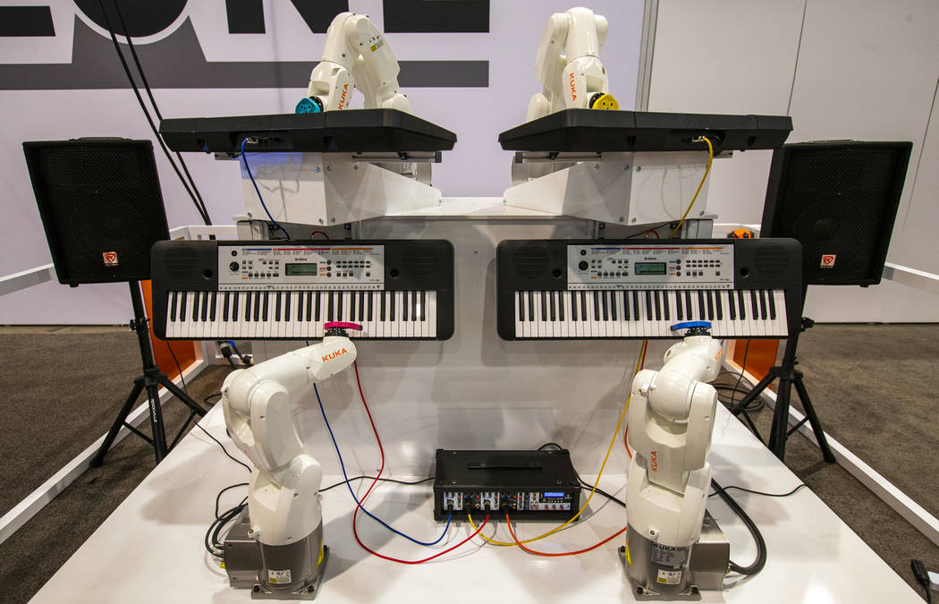 A Kuka Robot Band from ProMach Performance Services play pianos for attendees at PACK EXPO on M ...