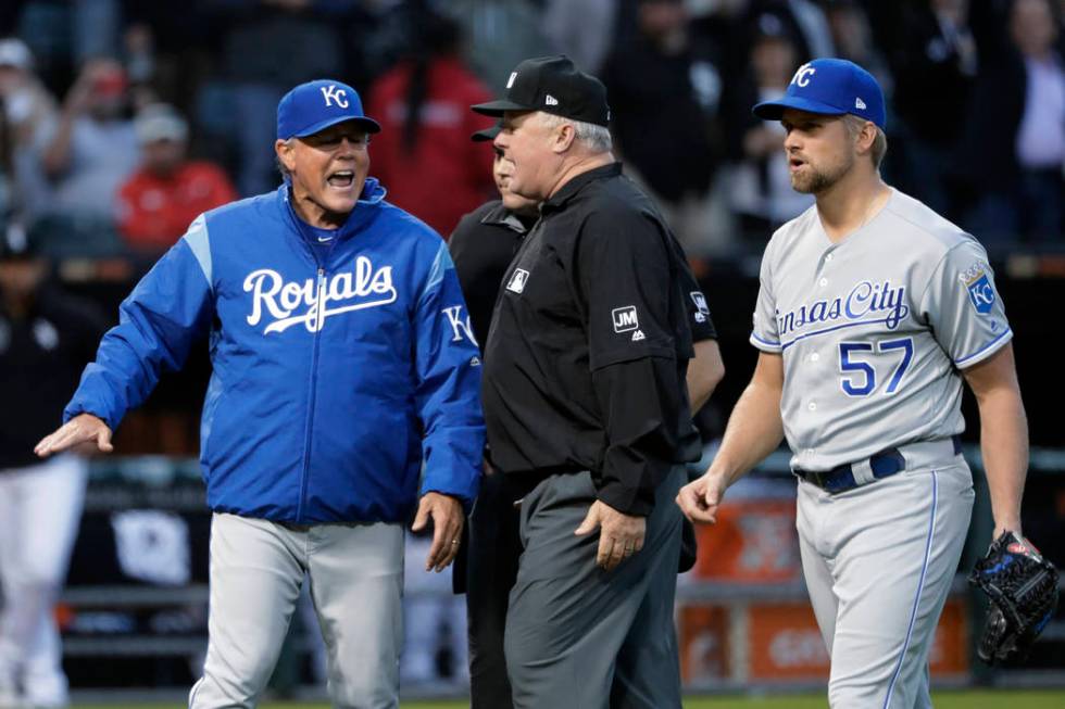 Kansas City Royals manager Ned Yost, left, appeals to umpire crew chief Bill Miller, center, af ...