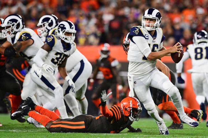 Los Angeles Rams quarterback Jared Goff (16) scrambles during the first half of an NFL football ...