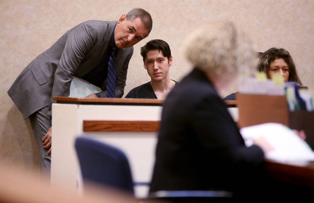 Giovanni Ruiz, 21, second from left, talks to his attorney, Gabriel Grasso, while waiting to ap ...