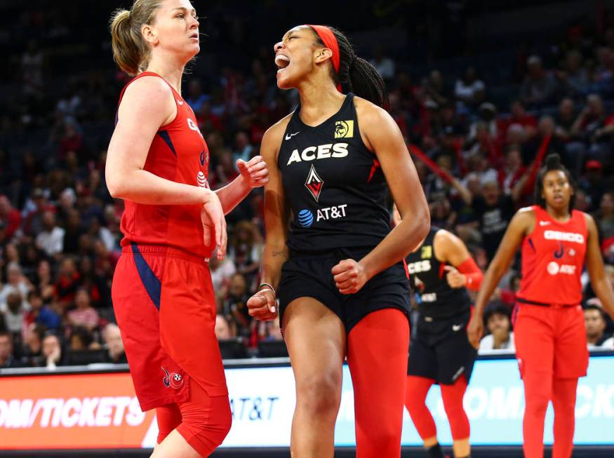 Las Vegas Aces' center A'ja Wilson, right, reacts after drawing a foul in front of Washington M ...