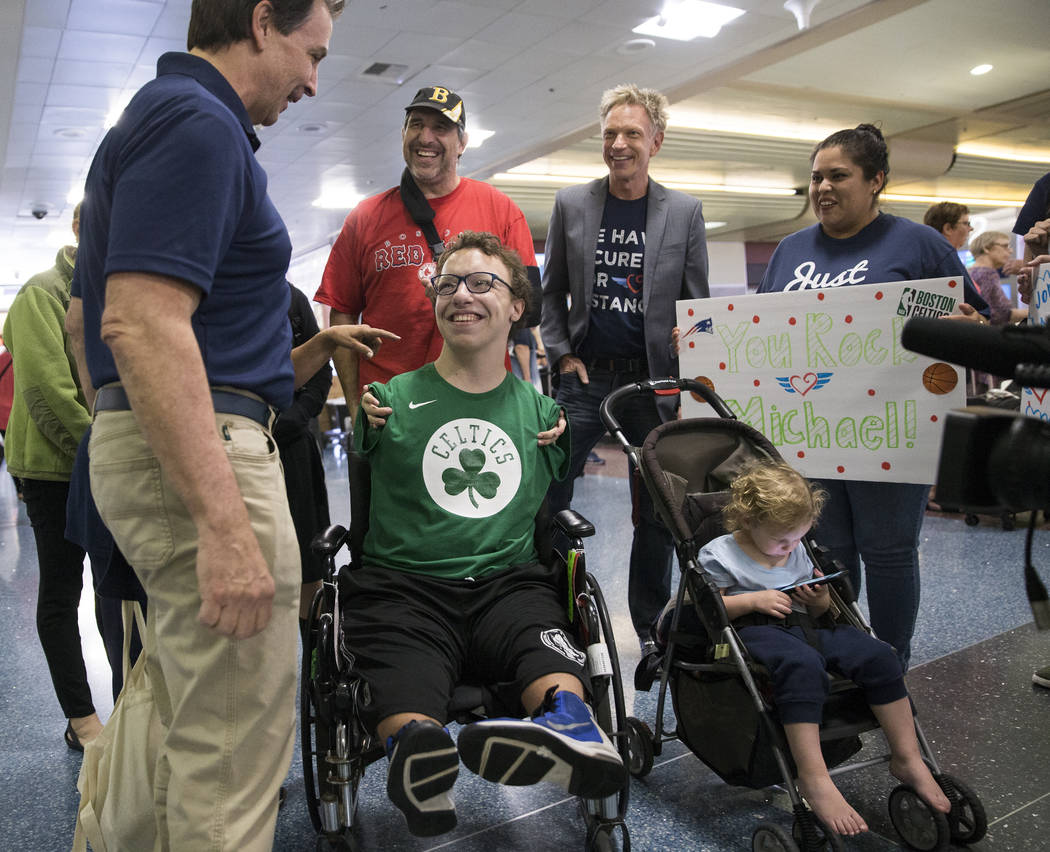 Miracle Flight CEO Mark Brown, left, talks with Michael Perrino, 16, from Mashpee, Mass., ...