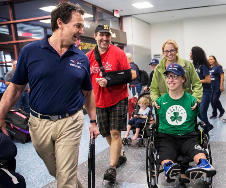Miracle Flight CEO Mark Brown, left, escorts John, Misty and Michael Perrino, 16, from Mas ...