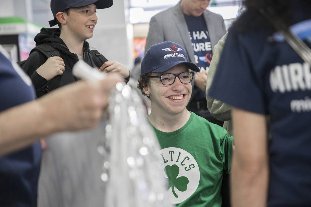 Michael Perrino, 16, from Mashpee, Mass., shares a laugh with Miracle Flight employees in ...