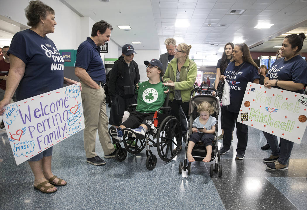 Miracle Flights staff talk with Michael Perrino, 16, and mom Misty, from Mashpee, Mass., i ...