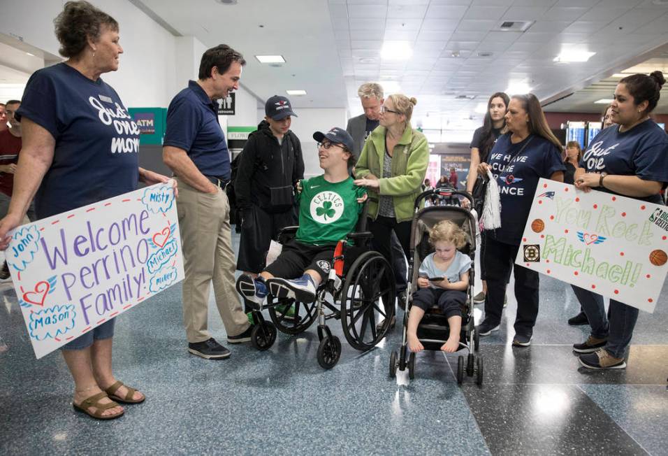 Miracle Flights staff talk with Michael Perrino, 16, and mom Misty, from Mashpee, Mass., i ...