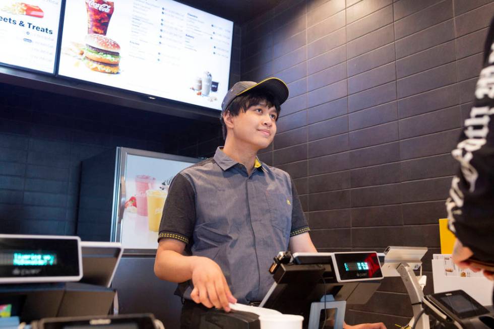 Crew member Jacob Zamora takes a customer's order at the McDonald's on the corner of Sahara Ave ...