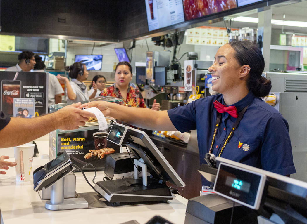 Crew member Glenda Osorio takes a costumer's order at the McDonald's on the corner of Sahara Av ...