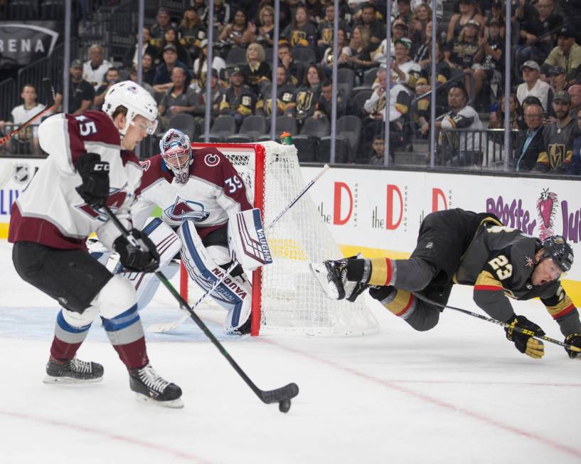 Vegas Golden Knights center Patrick Brown (23) takes a tumble while trying to take the puck fro ...