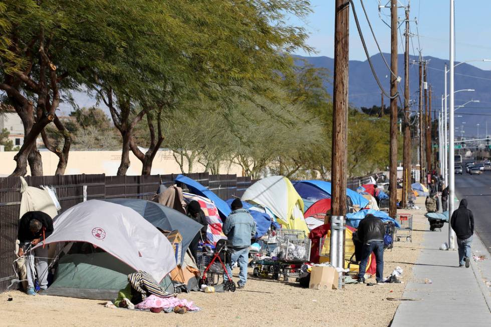 In this Feb.19 file photo, people secure their tents and tarps on Las Vegas Boulevard North ne ...