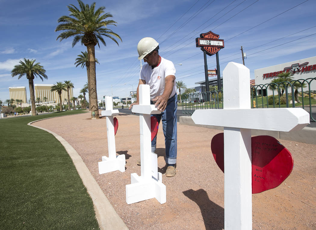 Greg Zanis, of Aurora, Ill., positions 58 crosses near the Welcome to Fabulous Las Vegas sign h ...