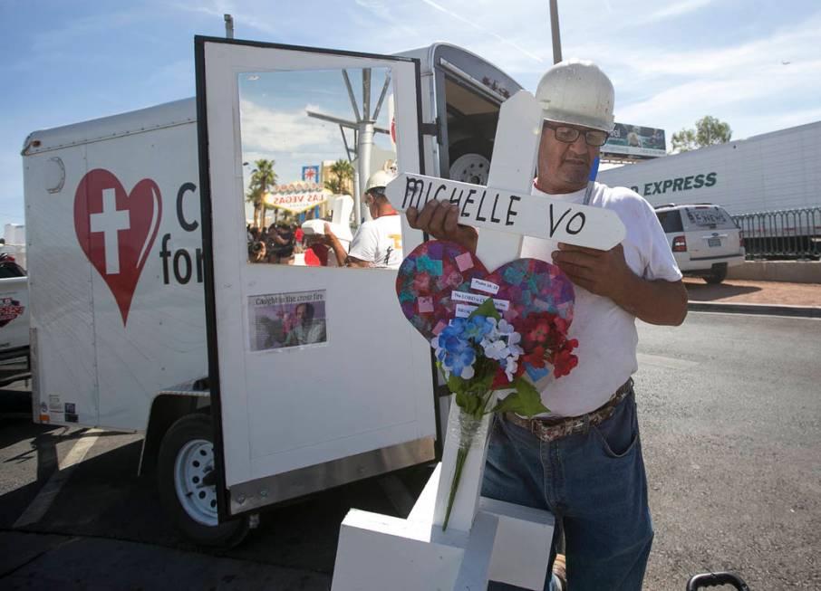 Greg Zanis, of Aurora, Ill., carries one of 58 crosses he placed near the Welcome to Fabulous L ...