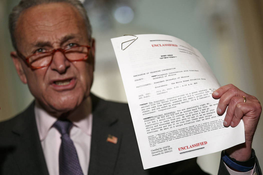 Senate Minority Leader Sen. Chuck Schumer of N.Y. holds up a copy of a White House released rou ...