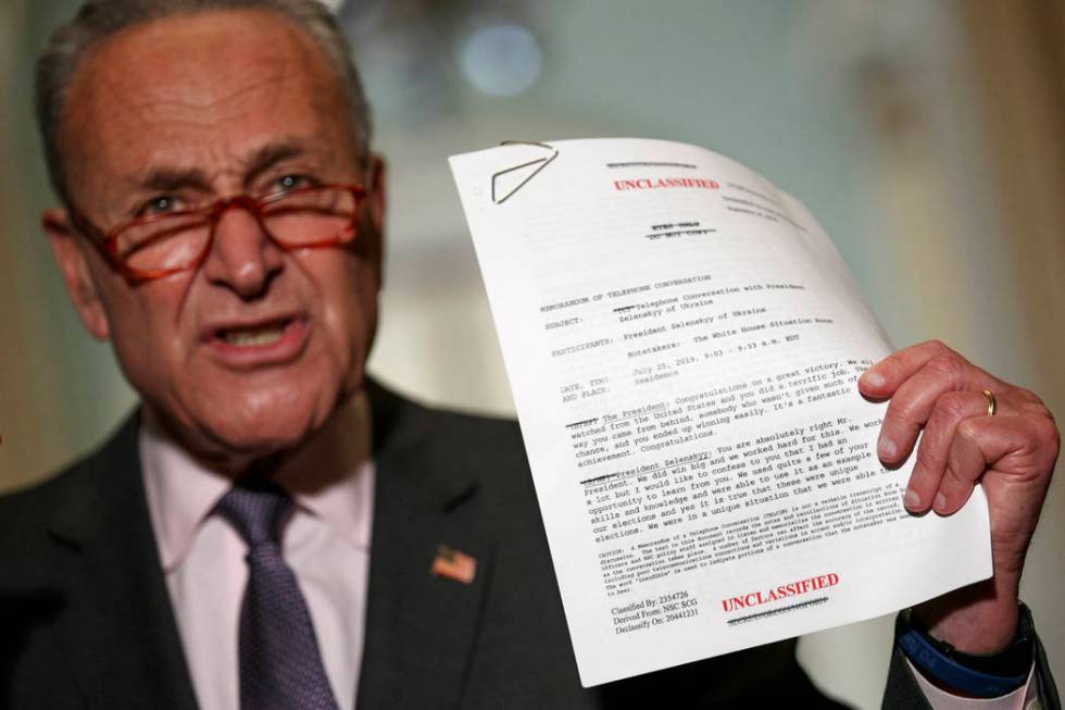 Senate Minority Leader Sen. Chuck Schumer of N.Y. holds up a copy of a White House released rou ...