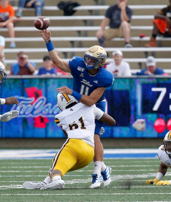 Tulsa's Zach Smith, right, is pressured by Wyoming's Solomon Bryd, left, during an NCAA colleg ...