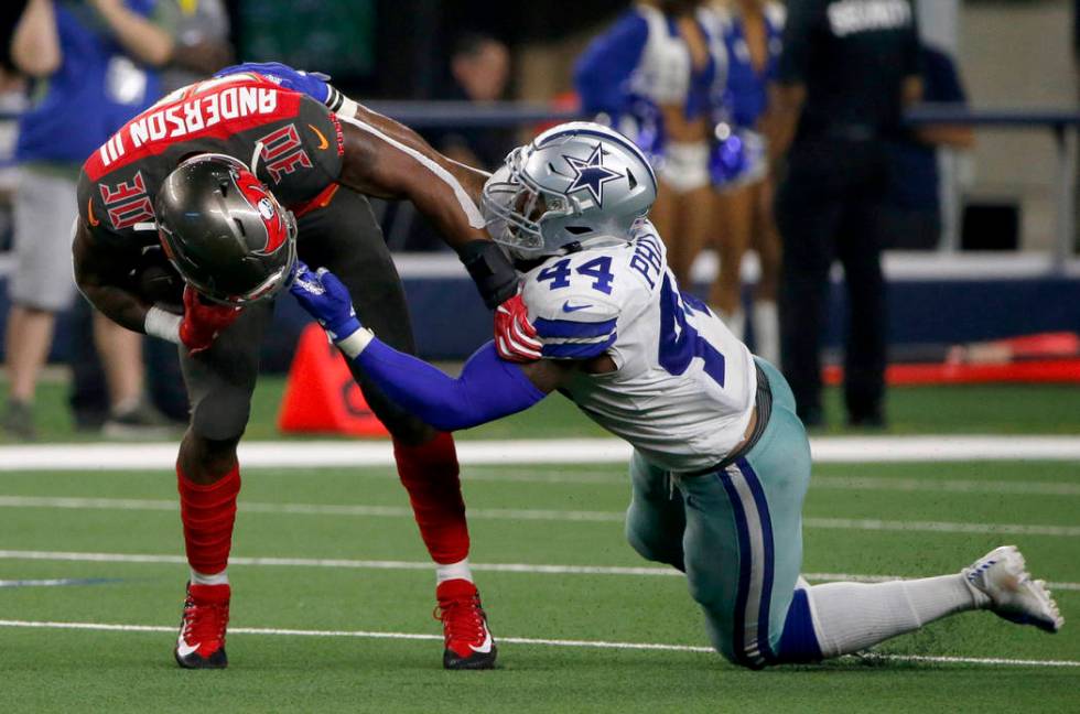 Tampa Bay Buccaneers running back Bruce Anderson III is stopped by the face mask by Dallas Cowb ...