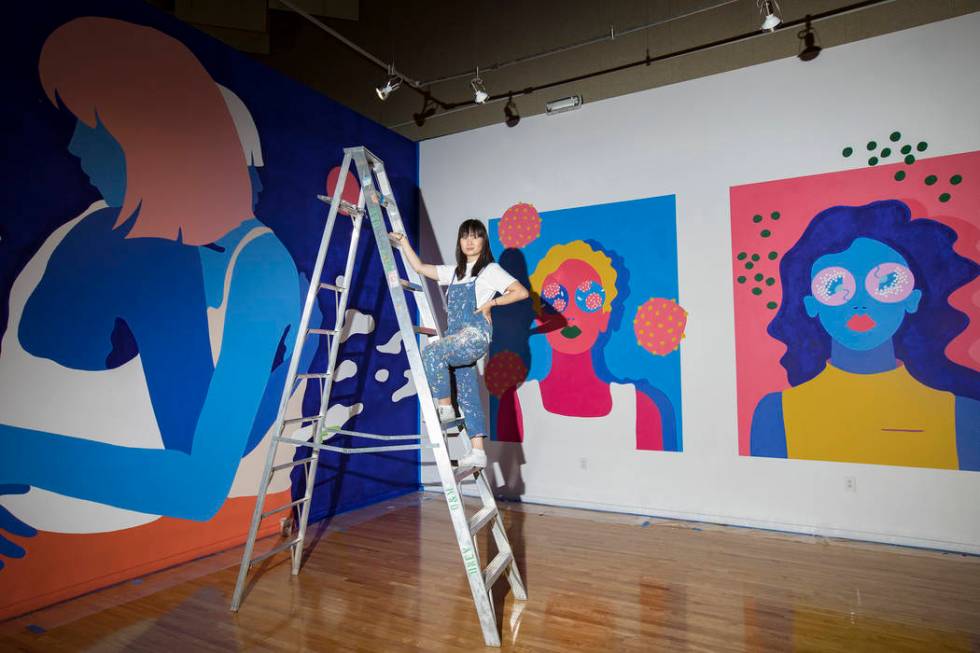 Amanda Phingbodhipakkiya, a neuroscientist-turned-artist, stands in front of her work at her ex ...