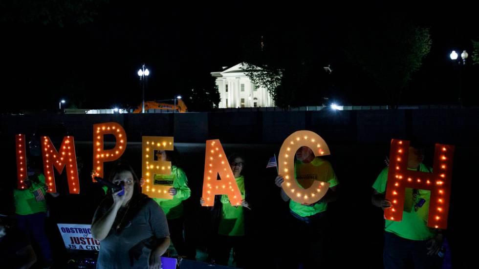 Protesters with "Kremlin Annex" call to impeach President Donald Trump in Lafayette S ...