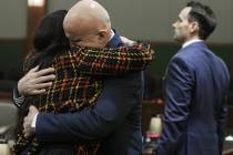 Las Vegas police Lt. James "Tom" Melton, second from left, hugs defense attorney Jean ...