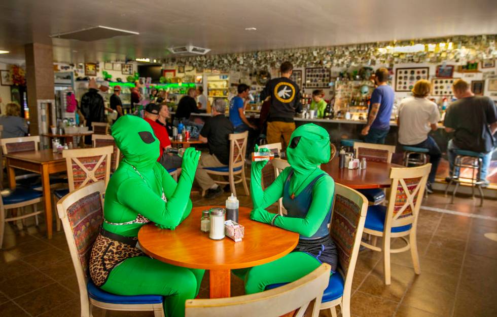 Invader Q-Tip, left, and Invader Stink enjoy a hot sauce breakfast at the Little A'Le'Inn Resta ...