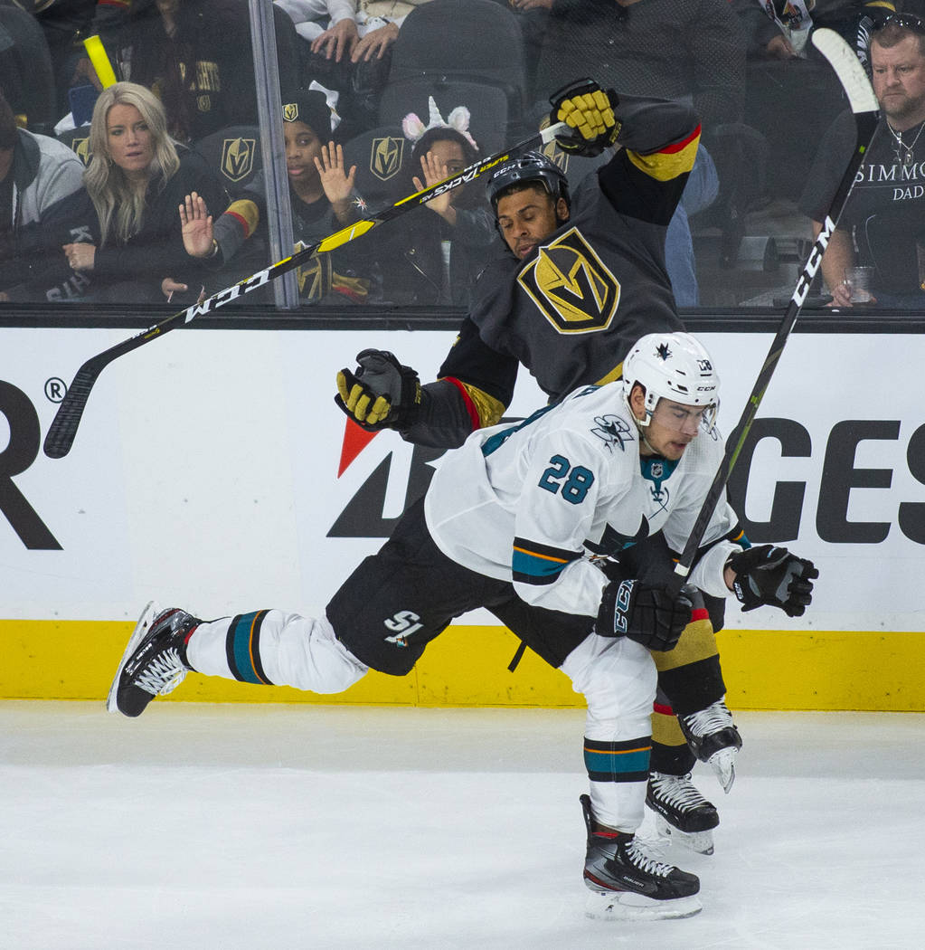 San Jose Sharks right wing Timo Meier (28) checks Golden Knights right wing Ryan Reaves (75) du ...