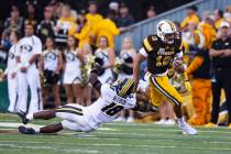 Wyoming quarterback Sean Chambers runs for a touchdown past Missouri defender Joshuah Bledsoe i ...