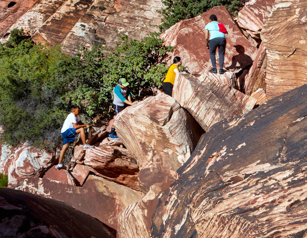 Visitors boulder in the Calico 1 area within the Red Rock Canyon National Conservation Area on ...