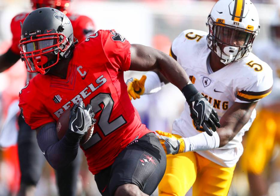 UNLV running back David Greene (22) runs the ball to score a touchdown as Wyoming cornerback Ri ...