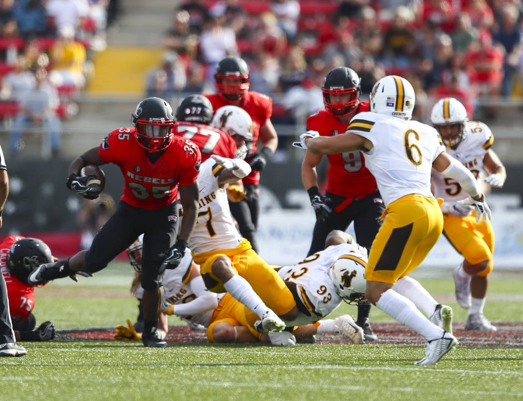 UNLV running back Xzaviar Campbell (35) runs the ball during a football game against Wyoming at ...