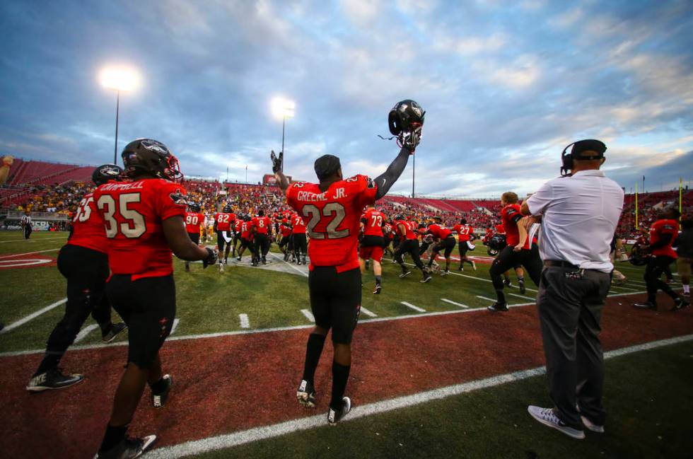 UNLV running back David Greene (22) celebrates upon defeating Wyoming 69-66 in a triple overtim ...