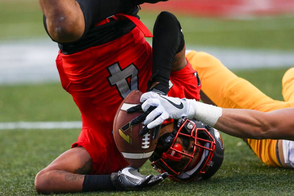 UNLV defensive back Torry McTyer (4) intercepts a pass intended for Wyoming wide receiver Jake ...