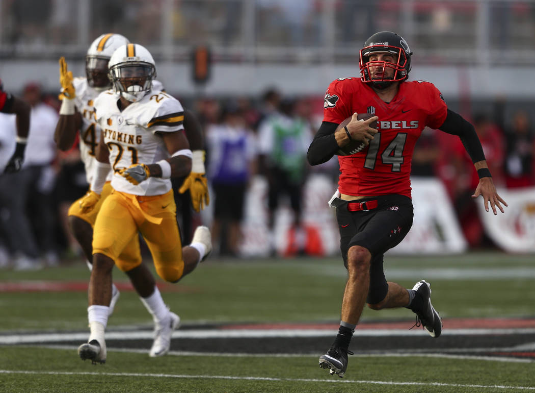 UNLV quarterback Kurt Palandech (14) runs the ball to score a touchdown during a football game ...