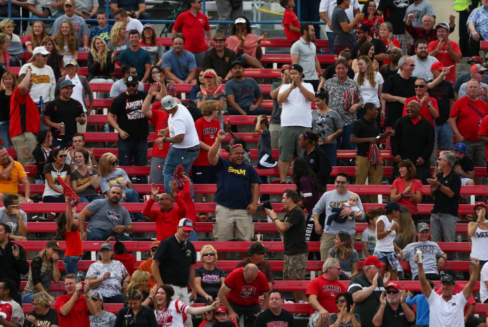 UNLV fans cheer after a touchdown by UNLV quarterback Kurt Palandech (14) during a football gam ...