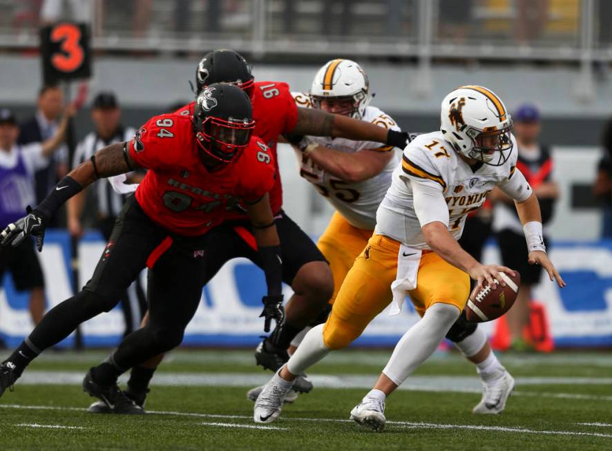 Wyoming cornerback DeAndre Watson (17) tries to avoid being sacked by UNLV defense during a foo ...