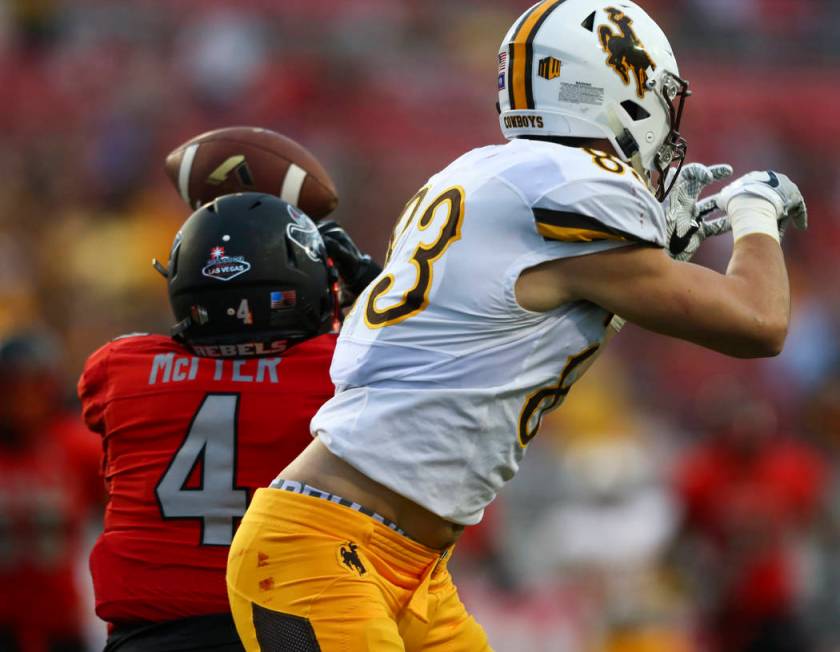 UNLV defensive back Torry McTyer (4) intercepts a pass intended for Wyoming wide receiver Jake ...