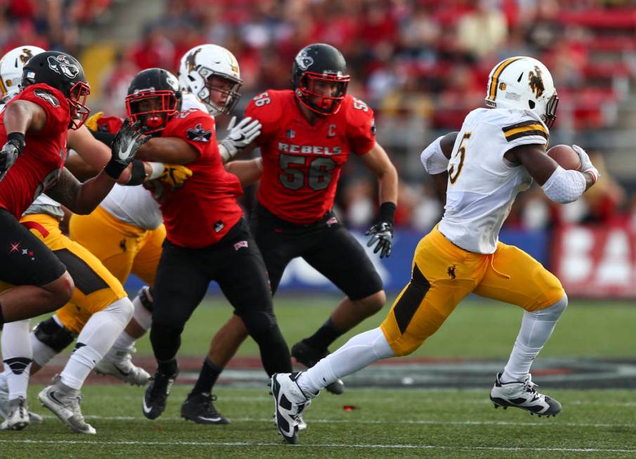 Wyoming running back Brian Hill (5) gets past UNLV defense during a football game at Sam Boyd S ...