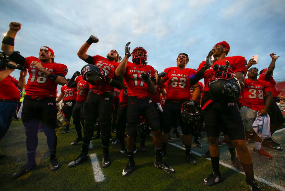 UNLV players celebrate after defeating Wyoming 69-66 in a triple overtime football game at Sam ...