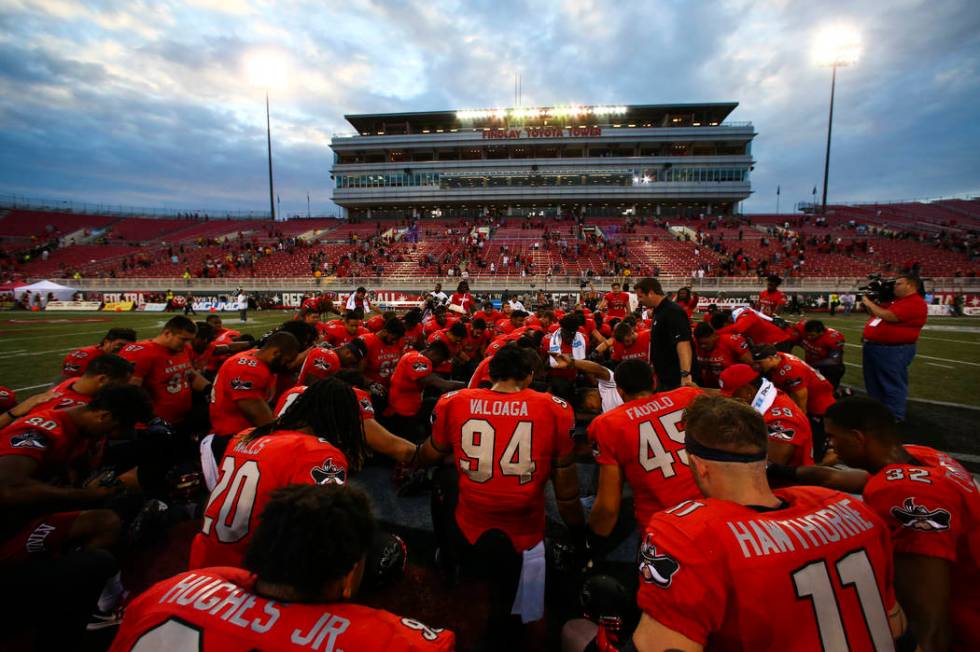 UNLV players huddle after defeating Wyoming 69-66 in a triple overtime football game at Sam Boy ...