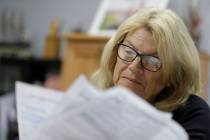 Linda Morris looks over her Medicare statements, Wednesday, Sept. 25, 2019, in Parker City, Ind ...