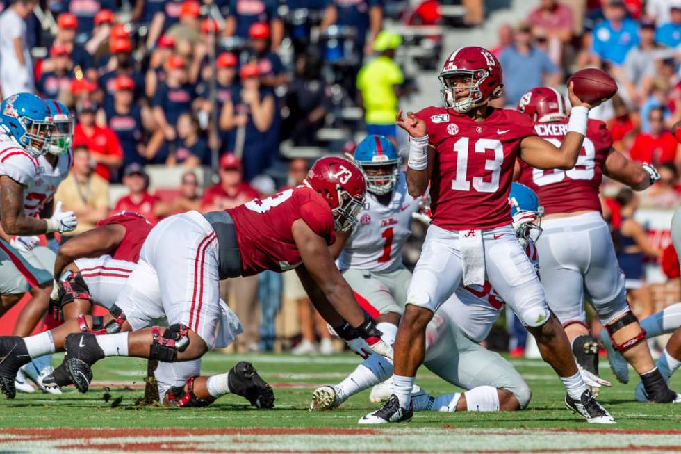 Alabama quarterback Tua Tagovailoa (13) throws to the edge against Mississippi during the first ...