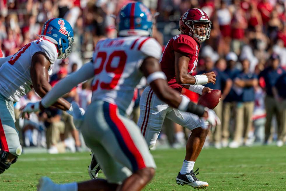 Alabama quarterback Tua Tagovailoa (13) rolls out against Mississippi during the first half of ...