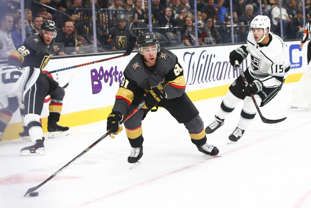 Golden Knights' Jonathan Marchessault (81) skates with the puck past Los Angeles Kings' Ben Hut ...