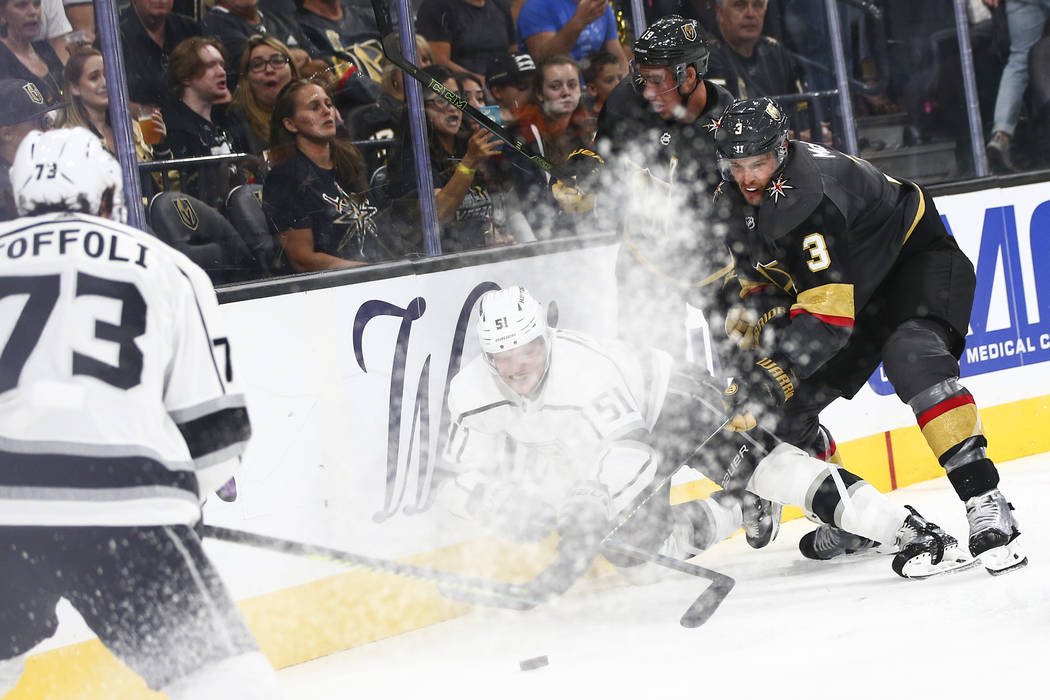 Los Angeles Kings' Austin Wagner (51) gets knocked to the ice by Golden Knights' Brayden McNabb ...