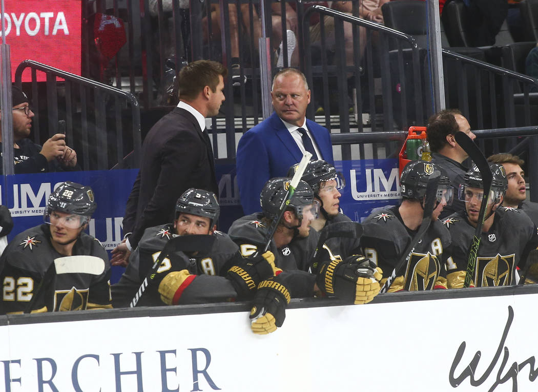 Golden Knights head coach Gerard Gallant, center, looks on during the second period of an NHL h ...