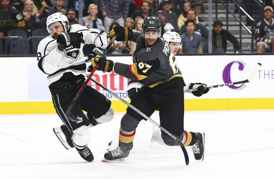 Golden Knights' Max Pacioretty (67) cross-checks Los Angeles Kings' Drew Doughty (8) during the ...