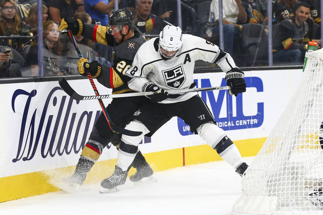 Golden Knights' William Carrier (28) and Los Angeles Kings' Drew Doughty (8) battle for the puc ...
